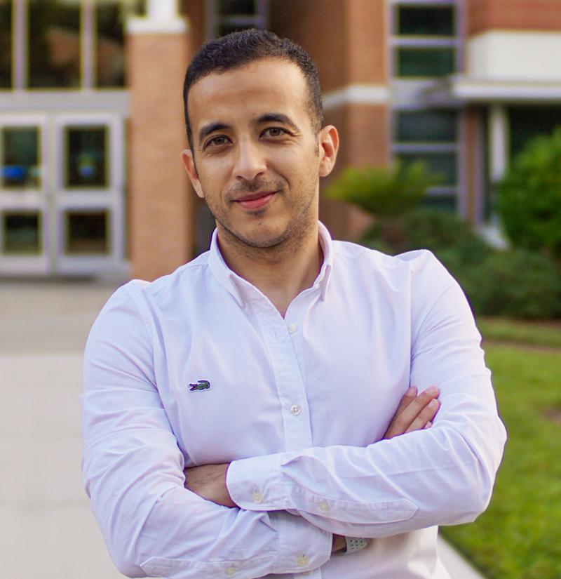 JU graduate student Ahmed Rashed standing in front of the Davis College of Business & Technology building.